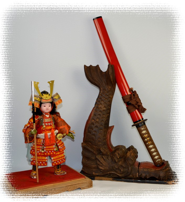 japanese antiquity:  samurai doll and antique wooden carved satnd for sword