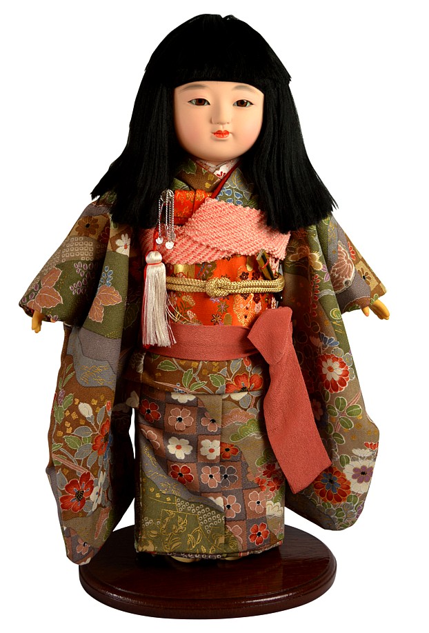 japanese traditional doll of a girl dressed with wonderful silk kimono