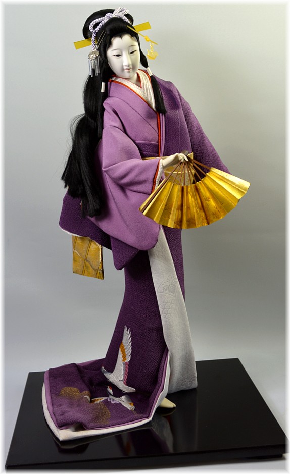japanese interior doll of a young woman dancing  with folding fan