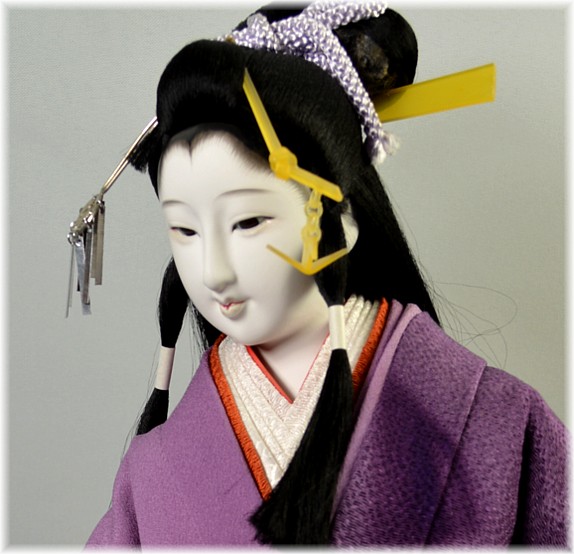 japanese interior doll of a young woman with folding fan