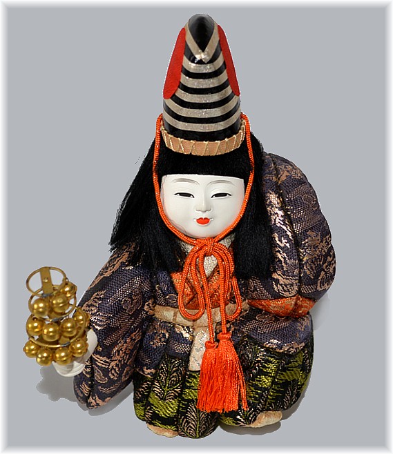 japanese kimekomi doll of a boy dancing with a rattle in his handl, 1950s