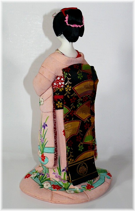 japanese traditional kimekomi doll of a lady with tea cup in her hands