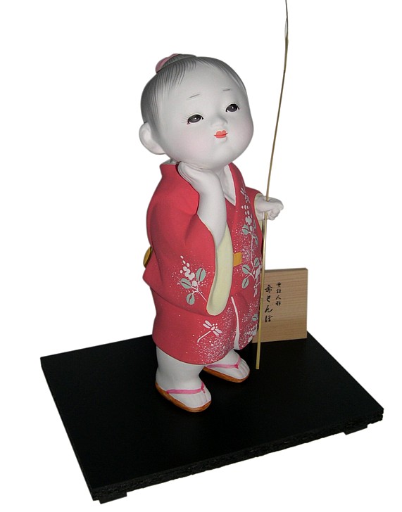 Japanese Hakata clay doll of a Boy in red kimono and with twig