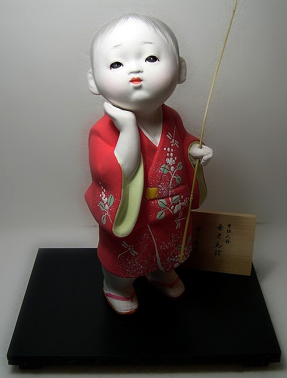 Japanese Hakata doll of a Boy  with twig