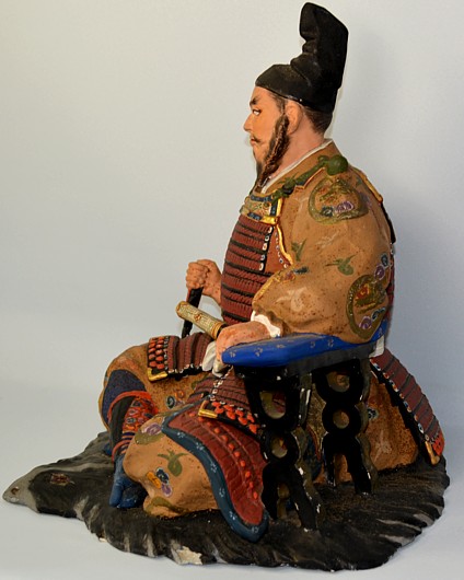 Shogun, sitting on bearskin, Japanese Hakata clay doll, 1950's. The Black Samurai Online Store