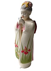 japanese hakata clay doll of a girl with lipstick and mirror